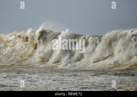 Detailed big breaking sea wave in a stormy but sunny day. Northern portuguese coast. Stock Photo