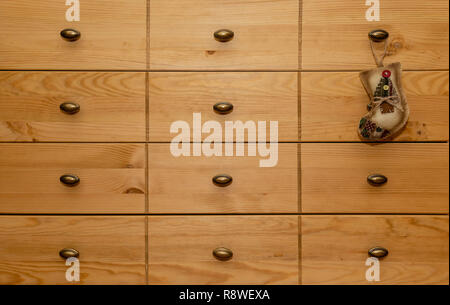 The christmas socks hangs on the chest of drawers. Stock Photo