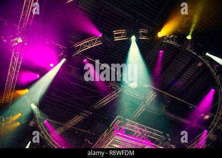 Stage lights on concert. Lighting equipment with multi-colored beams. Bottom view. Selective focus. Copy space Stock Photo