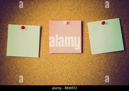 blank note papers on a cork board Stock Photo