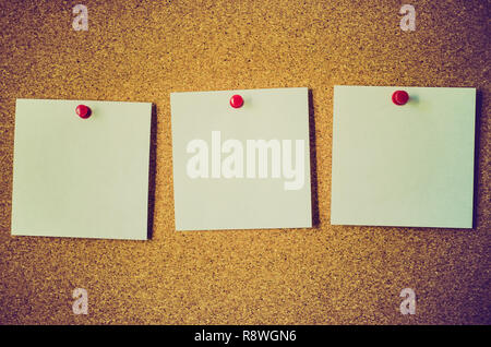blank note papers on a cork board Stock Photo