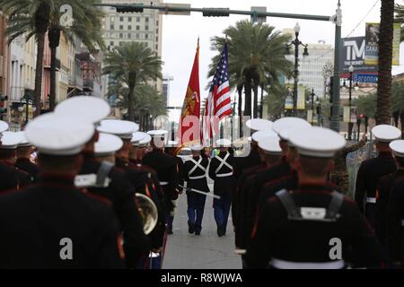 The 2nd Marine Aircraft Wing Band marches down the street during a Mardi Gras parade in New Orleans, Feb. 28, 2017. The band was led by drum major Sgt. Nathan Johnson, and played traditional jazz music and the Marines’ Hymn during the parade. The band followed the color guard that carried the American and Marine Corps flags. Stock Photo