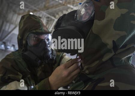 U.S. Airmen perform a buddy check during the first Rapid Ready Weasel ...