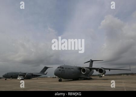 A KC-10 Extender, left, and a C-17 Globemaster III, both assigned to the 305th Air Mobility Wing is parked on the flight line at the Combat Readiness Training Center at Gulfport, Miss., in support of Crisis Response '17 March 5, 2017. Close to 700 Airmen with the 514th Air Mobility Wing, the 305th Air Mobility Wing, the 87th Air Base Wing, and the 621st Contingency Response Wing are participating in the mobilization exercise Crisis Response '17. Stock Photo