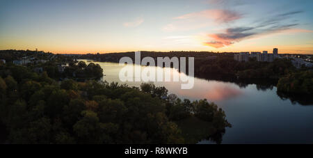 Aerial panoramic view of a Lake Banook in the Modern City during a vibrant Sunset. Taken in Halifax, Dartmouth, Nova Scotia, Canada. Stock Photo