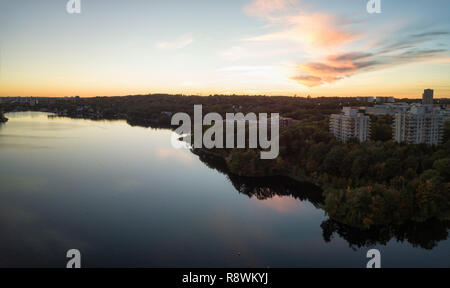 Aerial panoramic view of a Lake Banook in the Modern City during a vibrant Sunset. Taken in Halifax, Dartmouth, Nova Scotia, Canada. Stock Photo