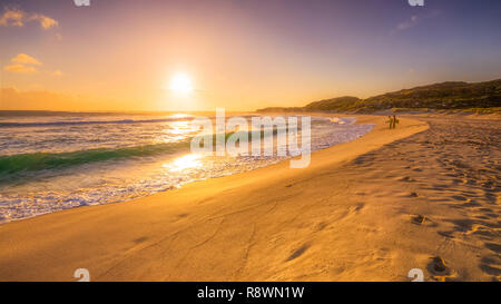 Sunset Surfers Stock Photo