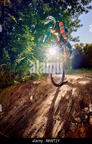 Moscow, Russia -  August 31, 2017: Mountain bike cyclist doing stoppie – ridden on the front wheel on a mtb bike. Biker riding extreme sport bicycle.  Stock Photo