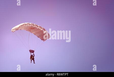 Cpl. Alex Thill parachutes through a red smoke grenade March 16, 2017 during parachute operations with the Republic of Korea Marine Corps at Josari drop zone, Republic of Korea, in support of Korea Marine Exercise Program 17-6. While each KMEP iteration is unique to the units involved and the training goals, all iterations are designed to increase the combined readiness. Thill, a Mitchell, South Dakota native, is an assistant radio operator with 3d Reconnaissance Battalion, 3rd Marine Division, III Marine Expeditionary Force. Stock Photo