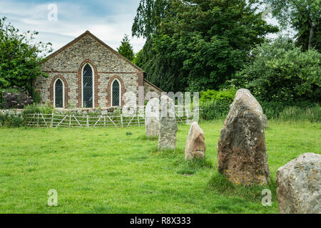 Neolithic stone circles and meadow with sheep grazing in the village of Avebury, Wiltshire, England, Europe. Stock Photo