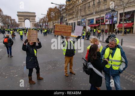 5th Yellow Vests demonstration (Gilets Jaunes) protesters against fuel tax, government, and French President Macron with slogan at Champs-Élysées Stock Photo