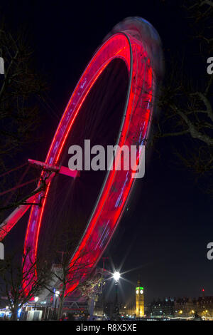 London Eye or Millenium Wheel, is a 135-meter observation wheel from where you can have spectacular views of London, at night and red is spectacular Stock Photo