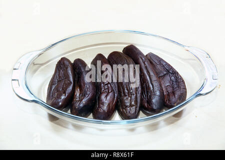 Arrangement of Raw Small Eggplants In Bowl isolated on White background. Focus on Foreground - Image Stock Photo