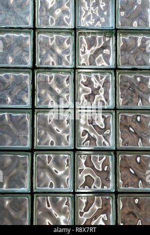 Colorful light patterns on translucent architectural glass block wall Stock Photo