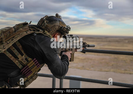 A U.S. Army Green Beret, assigned to 10th Special Forces Group (Airborne), shoots targets from a designated shooting position during the stress shoot portion of advanced skills training on Fort Carson, Colorado, Dec. 10, 2018.  The purpose of the training was to give the Soldiers opportunities to hone their skills on long-range precision fires from a variety of locations and positions. (U.S. Army photo by Sgt. Connor Mendez) Stock Photo