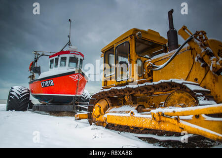 Tractor and Fishing Boats in the snow at Aldeburgh Suffolk England Stock Photo