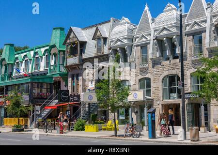 Canada, Province of Quebec, Montreal, Plateau-Mont-Royal, Saint-Denis Street with its shops and houses with typical Montreal architecture Stock Photo