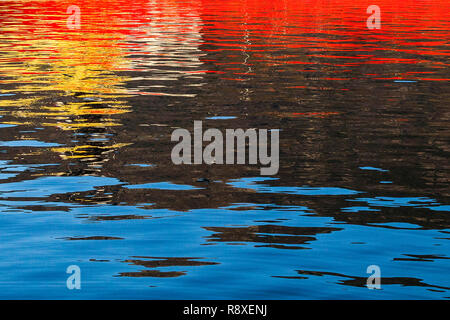 Reflections from a ship throwing interesting patterns on the water Mirror image on water. Stock Photo