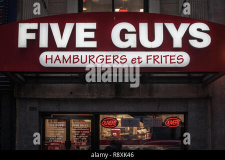 MONTREAL, CANADA - NOVEMBER 5, 2018: Five Guys logo on their main fast food restaurant for Montreal, Quebec, iwith their slogan in French. Five guys i Stock Photo