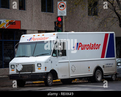 MONTREAL, CANADA - NOVEMBER 6, 2018: Purolator logo on one of their delivery trucks in a street of Montreal, Quebec. Purolator is a Canadian courier s Stock Photo