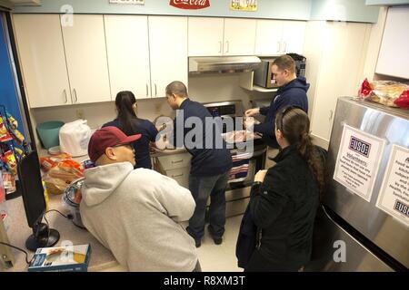 Members of the Air Force Sergeant’s Association prepare for their March 10 mentorship event at the United Services Organization by cooking bacon-wrapped hotdogs. The event was designed to create an environment where Airmen could speak honestly and have tough questions answered. Stock Photo