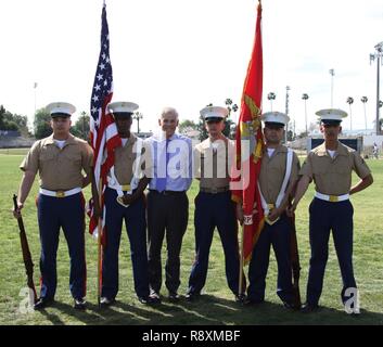 Left to right, Marine Corps Recruiters Sgt. Elijah Gable, Sgt. Derrick Berrian, Mr. Dennis Mulhaupt, president of St. John Bosco High School, SSgt. Phillip Page, Sgt. Victor Romualdo and LCpl. Ulixes Hernandez, pose during a varsity baseball game at St. John Bosco High School, Bellflower, Calif., March 14, 2017. Coming from Recruiting Substation Lakewood, the recruiters were the official color guard for the game. Stock Photo