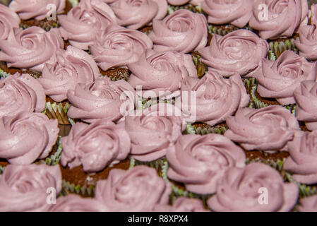 Chocolate cupcakes decorated with close up rose piping icing selective focus Roses cakes Stock Photo