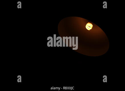Little light of a lamp in the darkness with free space for text or design Stock Photo