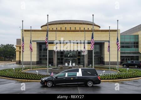 A hearse carrying the casket of former President George H. W. Bush stops for a moment in front of the George Bush Library and Museum during his funeral in College Station, Texas, Dec. 6, 2018. Nearly 4,000 military and civilian personnel from across all branches of the U.S. armed forces, including Reserve and National Guard components, provided ceremonial support during the state funeral of George H. W. Bush, the 41st President of the United States. Stock Photo