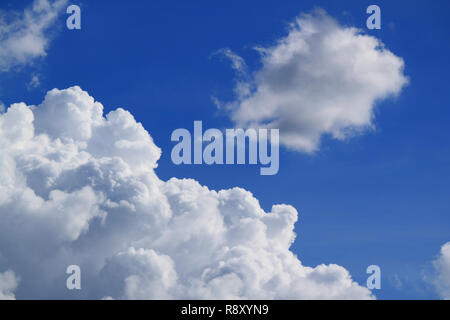 White Fluffy Cumulus Clouds Floating on Vibrant Blue Sky Stock Photo