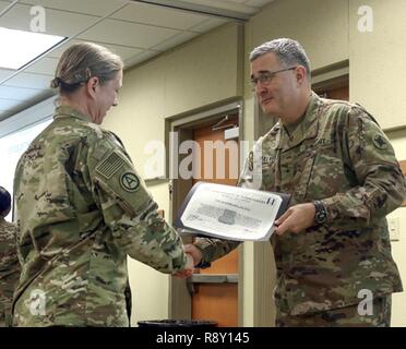 Staff Sgt. Alana Harrigill, 184th Sustainment Command receives a Hero of The Battle certificate from Brig. Gen. Clint E. Walker, 184 SC commander. Harrigill was awarded for her professionalism and proficiency during the units validation for the upcoming deployment. Stock Photo