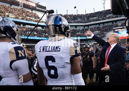 President Donald J. Trump tosses the coin before the 2018 Army-Navy Game in Philadelphia, Pennsylvania, Dec. 8, 2018. The U.S. Military Academy (West Point) beat the U.S. Naval Academy 17-10. Stock Photo