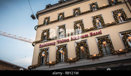 Basel, Switzerland - December 25, 2017: facade of the toy museum decorated for Christmas with garlands and balls Stock Photo