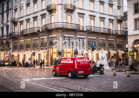 Milan, Italy - November 2, 2017: Pedestrians and car traffic on a