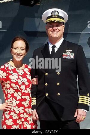 NORFOLK (March 4, 2017) Capt. Douglas Stephens, deputy chief of staff of manpower and personnel at Navy Medicine East stands with his daughter, Hannah Stephens, during his promotion ceremony held aboard the guided-missile destroyer USS Oscar Austin (DDG 79) March 4.  NME is one of two regional commands that manage Navy Medicine's global health care network by overseeing the delivery of medical, dental and other health care services to approximately one million patients across almost 100 facilities across the eastern hemisphere. Stock Photo