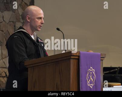 Steel Worker 2nd Class Calvin Huckabee, with Underwater Construction Team Two, delivers remarks at the memorial service for WWII Veteran Ken Hartle, nicknamed “Old Deep Sea” in Escondido, California, March 4, 2017. Thought to be the oldest living Pearl Harbor salvage diver, Hartle was 103 when he died, Jan. 24, 2017. Stock Photo