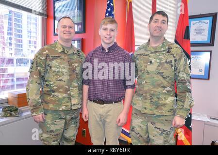 Maj. Christopher Burkhart, Nashville District deputy commander (left) Charles Nissen a sophomore student from Montgomery Bell Academy (center) and Lt. Col. Stephen L. Murphy, Nashville District commander, pose for a photo after Nissen receives a brief on the district. Nissen, a sophomore student from Montgomery Bell Academy spent the day shadowing U. S. Army Corps of Engineers Nashville District engineers. Stock Photo