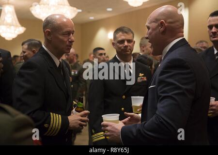 Sgt. Maj. Micheal Barrett (ret.), right, speaks to Marines and Sailors with 1st Marine Logistics Group during the 1st MLG Officer and Staff Noncommissioned Officer Mess Night at Camp Pendleton, Calif., March 3, 2017. Barrett, the 17th Sergeant Major of the Marine Corps, was the honored guest at the mess night, an event designed to foster camaraderie and esprit de corps. Stock Photo