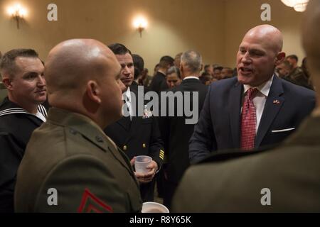 Sgt. Maj. Micheal Barrett (ret.), right, speaks to Marines and Sailors with 1st Marine Logistics Group during the 1st MLG Officer and Staff Noncommissioned Officer Mess Night at Camp Pendleton, Calif., March 3, 2017. Barrett, the 17th Sergeant Major of the Marine Corps, was the honored guest at the mess night, an event designed to foster camaraderie and esprit de corps. Stock Photo