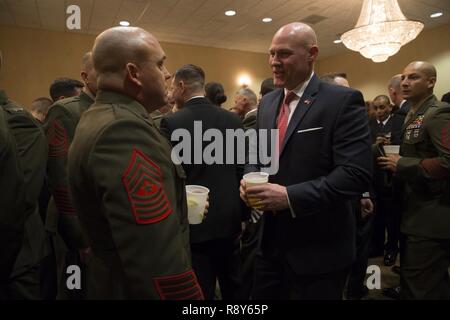 Sgt. Maj. Micheal Barrett (ret.), right, speaks to Marines and Sailors with 1st Marine Logistics Group during the 1st MLG Officer and Staff Noncommissioned Officer Mess Night at Camp Pendleton, Calif., March 3, 2017. Barrett, the 17th Sergeant Major of the Marine Corps, was the honored guest at the mess night, an event designed to foster camaraderie and esprit de corps. Stock Photo