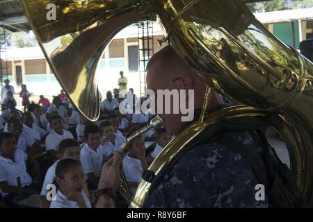 TRUJILLO, Honduras (Feb. 27, 2017) - Musician 1st Class Christopher Jerome, a native of Harrisonburg, Va., Assigned to U.S. Fleet Forces (USFF) Band, Norfolk Va., plays a sousaphone for host nation school children during a U.S. Band concert during Continuing Promise 2017 (CP-17) in Trujillo, Honduras.  CP-17 is a U.S. Southern Command-sponsored and U.S. Naval Forces Southern Command/U.S. 4th Fleet-conducted deployment to conduct civil-military operations including humanitarian assistance, training engagements, medical, dental, and veterinary support in an effort to show U.S. support and commit Stock Photo