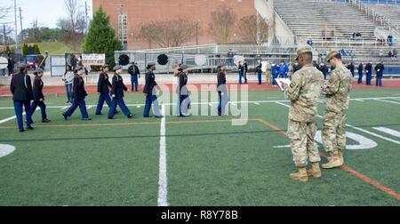 Two soldiers from the 335th Signal Command (Theater) grade an unarmed female squad during an annual JROTC drill and ceremony competition, Feb. 25, in Atlanta, Georgia. Stock Photo