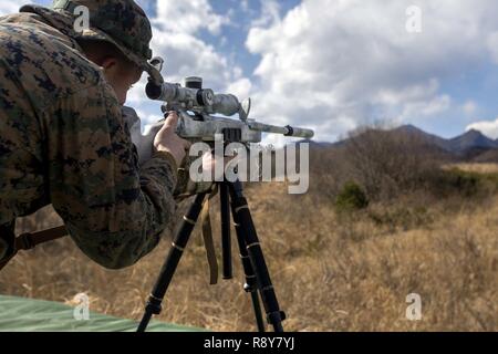 U.S. Marine Corps Cpl. Tyler Harbert, a Colorado Springs, Colorado native, fires at a target in the standing position using a M40A5 sniper rifle during exercise Forest Light at Somagahara, Japan, March 8, 2017. Forest Light is one of various bilateral training opportunities conducted by Japanese Ground Self Defense and forward deployed U.S. Marine Corps forces to demonstrate the enduring commitment by both countries to peace, stability, and prosperity across the region. Harbert is the assistant team leader for scout sniper platoon, Golf Company, 2nd Battalion, 3rd Marine Regiment, which suppor Stock Photo