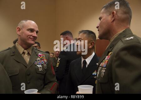 Sgt. Maj. Troy E. Black, sergeant major of 1st Marine Logistics Group, left, speaks to Marines and Sailors with 1st MLG during the 1st MLG Officer and Staff Noncommissioned Officer Mess Night at Camp Pendleton, Calif., March 3, 2017. The event is designed to foster camaraderie and esprit de corps. Stock Photo