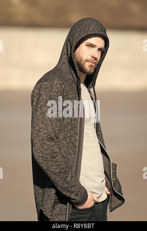 Macho with beard in hoodie on sunny outdoor, fashion. Man wear sweatshirt, casual style. Mens fashion, style, sportswear. Lifestyle for active and healthy man, sport. Stock Photo