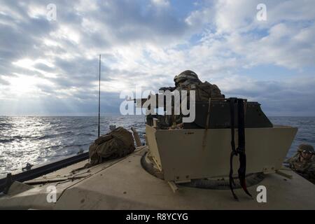 OKINAWA, Japan (March 12, 2017) Cpl. Frank West, assigned to Battalion Landing Team, 2nd Battalion, 5th Marines, stands watch inside a high mobility multipurpose wheeled vehicle aboard landing craft utility (LCU) 1666. LCU 1666, assigned to Naval Beach Unit 7, disembarked from the amphibious transport dock ship USS Green Bay (LPD 20) to conduct a combat rubber raiding craft beach raid with the Marines. Green Bay, part of the Bonhomme Richard Expeditionary Strike Group, with embarked 31st Marine Expeditionary Unit, is on a routine patrol, operating in the Indo-Asia-Pacific region to enhance war Stock Photo