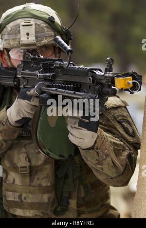 A U.S. Army Soldier assigned to Company A (Easy Company), 2nd Battalion, 506th Infantry Regiment, 101st Airborne Division (Air Assault) engages the enemy during a hasty raid training exercise at Warrior Exercise 78-17-01 at Joint Base McGuire-Dix-Lakehurst March 16, 2017. Easy Company kicked off WAREX 78-17-01 during a joint-component airfield seizure on March 13, 2017. Roughly 60 units from the Army Reserve, Army, Air Force, Marine Reserves, and Canadian Armed Forces participated in the 84th Training Command’s joint training exercise, WAREX 78-17-01 from March 8 to April 1, 2017; the WAREX is Stock Photo