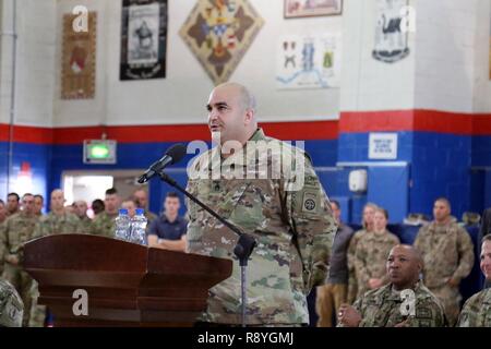 Retired Army Staff Sgt. George Perez, airborne infantryman, formerly with B company, 1st of 504th Parachute Infantry Regiment,  82nd Airborne Division, talks about how he lost his leg in Iraq, during a town hall meeting March 14 at Camp Arifjan. As a Soldier with Operation Proper Exit, Perez has an opportunity to return to the area where he was injured and depart on his own terms. Stock Photo