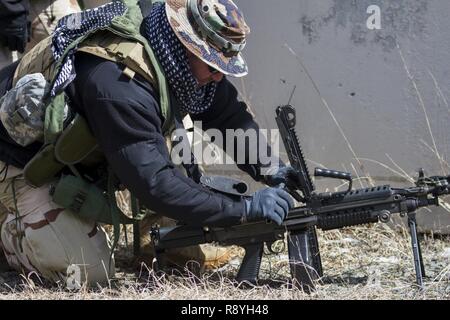 A U.S. Army Reserve Soldier assigned to the 78th Training Division, clears the chamber of his weapon before U.S. Army Soldiers assigned to the 101st Airborne Division (Air Assault) conduct a hasty raid at Hosteel Village near Joint base McGuire-Dix-Lakehurst on March 16, 2017, as a part of Warrior Exercise 78-17-01 which is designed to assess a units’ combat capabilities.  Army Reserve Soldiers assigned to the 363rd Military Police Company served as the oppositional force for Easy Company, 2nd Battalion, 506th Infantry Regiment, 101st Airborne Division during the exercise. Roughly 60 units fro Stock Photo