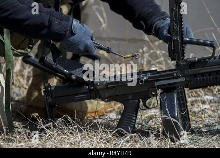 A U.S. Army Reserve Soldier assigned to the 78th Training Division, clears the chamber of his weapon before U.S. Army Soldiers assigned to the 101st Airborne Division (Air Assault) conduct a hasty raid at Hosteel Village near Joint base McGuire-Dix-Lakehurst on March 16, 2017, as a part of Warrior Exercise 78-17-01 which is designed to assess a units’ combat capabilities.  Army Reserve Soldiers assigned to the 363rd Military Police Company served as the oppositional force for Easy Company, 2nd Battalion, 506th Infantry Regiment, 101st Airborne Division during the exercise. Roughly 60 units fro Stock Photo